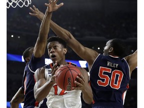 Virginia guard De'Andre Hunter (12) drives to the basket past Auburn center Austin Wiley, right, during the second half in the semifinals of the Final Four NCAA college basketball tournament, Saturday, April 6, 2019, in Minneapolis.