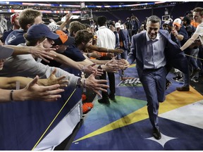 Virginia head coach Tony Bennett celebrates with fans after the championship game against Texas Tech in the Final Four NCAA college basketball tournament, Monday, April 8, 2019, in Minneapolis. Virginia won 85-77 in overtime.