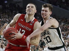Texas Tech guard Matt Mooney drives to the basket past Michigan State guard Matt McQuaid, right, during the second half in the semifinals of the Final Four NCAA college basketball tournament, Saturday, April 6, 2019, in Minneapolis.