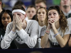Michigan State fans react at the end of a semifinal round game against Texas Tech in the Final Four NCAA college basketball tournament, Saturday, April 6, 2019, in Minneapolis.