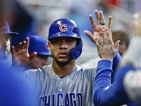 Chicago Cubs' Willson Contreras (40) celebrates in the dugout after he scored during the second inning of the team's baseball game against the Miami Marlins on Wednesday, April 17, 2019, in Miami.