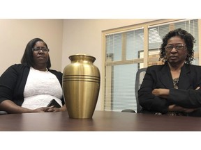 Corene Nero, right, and her daughter Gloria Rolle speak at their attorneys office next to an urn with cremated remains, in Boca Raton, Fla., Tuesday, April 16, 2019. Robert Nero Sr., passed away in 2013 and was cremated by Taylor Smith funeral home. In March, West Palm Beach police Department found a box with Robert Nero's name on it filled with ashes. Now the family is demanding answers from the funeral home and want to return the remains they have to the right family.