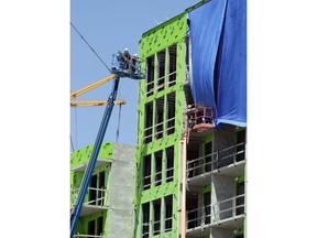 In this Tuesday, April 16, 2019, photo, workers labor at an apartment building near downtown Orlando, Fla. The U.S. Census Bureau said Thursday, April 18 that Orlando grew by 60,000 people from mid-2017 to mid-2018, making it the fifth biggest metro increase in pure numbers in the nation.