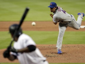 New York Mets starting pitcher Jason Vargas throws to Miami Marlins' Curtis Granderson during the first inning of a baseball game, Tuesday, April 2, 2019, in Miami.