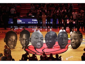 Cutout heads chronicling the career of Miami Heat guard Dwyane Wade sit on the court during a ceremony to honor Wade who is playing his final home regular season game when the Heat host the Philadelphia 76ers, Tuesday, April 9, 2019, in Miami. Wade is retiring at the end of the season.