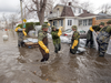 Canadian Forces personnel sandbag a house against the floodwaters, April 25, 2019 in Laval, Que.