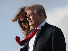 President Donald Trump and first lady Melania Trump, walk down the stairs of Air Force One during their arrival at Palm Beach International Airport, Thursday, April 18, 2019, in West Palm Beach, Fla. Trump traveled to Florida to spend the Easter weekend as his Mar-a-Lago estate.