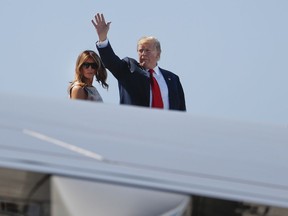President Donald Trump, right, waves as he and first lady Melania Trump board Air Force One prior to departure from Palm Beach International Airport, Sunday, April 21, 2019, in West Palm Beach Fla.