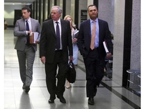 Attorneys Jack Goldberger, center, Alex Spiro, left, and William Burck, the defense team for New England Patriots owner Robert Kraft, make their way to Courtroom 2E at the Palm Beach County Courthouse, Friday, April 12, 2019, in West Palm Beach, Fla., for a status hearing in a prostitution case against Kraft.
