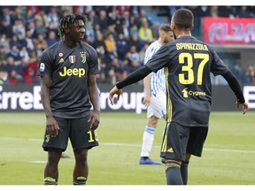 Juventus' Moise Kean, left, celebrates with his teammate Leonardo Spinazzola after scoring his side's opening goal during the Serie A soccer match between Spal and Juventus, at the Paolo Mazza stadium in Ferrara, Italy, Saturday, April 13, 2019.