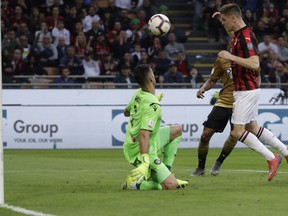 AC Milan's Krzysztof Piatek scores his side's opening goal during the Serie A soccer match between AC Milan and Udinese, at the San Siro stadium in Milan, Italy, Tuesday, April 2, 2019.