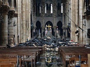 Daylight makes clear the fire damaged wood and stone near the altar inside Notre Dame Cathedral in Paris, France, on Tuesday, April 16, 2019.