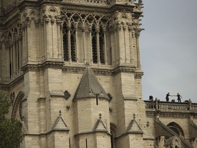 Technicians work on top of the Notre Dame cathedral in Paris, Monday, April 22, 2019. In the wake of the fire last week that gutted Notre Dame, questions are being raised about the state of thousands of other cathedrals, palaces and village spires that have turned France -- as well as Italy, Britain and Spain -- into open air museums of Western civilization.