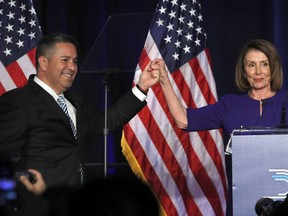 FILE - In this Nov. 6, 2018 file photo, DCCC Chair Ben Ray Luján, left, and House Democratic Leader Nancy Pelosi of Calif., gesture after speaking to a crowd of volunteers and supporters of the Democratic party at an election night event at the Hyatt Regency Hotel in Washington. U.S. Rep. Ben Ray Luján will run for New Mexico's open U.S. Senate seat in 2020. The 46-year-old Democrat announced his Senate bid Monday, April 1, 2019, in a video posted on Twitter that takes aim at Republican Senate leadership. Luján hails from a prominent New Mexico political family and helped his party retake the U.S. House majority in 2018 midterm elections.