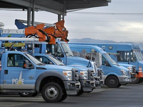 FILE - In this Jan. 14, 2019, file photo, Pacific Gas & Electric vehicles are parked at the PG&E Oakland Service Center in Oakland, Calif. California's PG&E has asked state regulators for a hefty increase in rates and profits, saying the hike is needed for wildfire safety and to attract investment as the utility goes through bankruptcy.