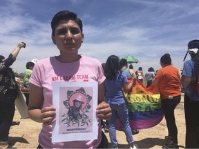 FILE - In this June 6, 2018, file photo, Gabriela Hernandez, executive director of the nonprofit New Mexico Dream Team, holds up an image in Albuquerque, N.M, of Roxsana Hernandez , a Honduran transgender woman who died while in U.S. custody. An autopsy released Tuesday, April 9, 2019, concluded that Hernandez died of complications from AIDS in May 2018.