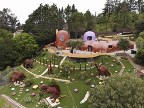 This Monday, April 1, 2019 photo, shows an aerial view of the Flintstone House in Hillsborough, Calif. The San Francisco Bay Area suburb of Hillsborough is suing the owner of the house, saying that she installed dangerous steps, dinosaurs and other Flintstone-era figurines without necessary permits. The owner and her attorney say they will fight for the rights of property owners and Fred and Barney fans everywhere.