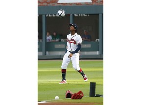 Atlanta Braves left fielder Ronald Acuna Jr. plays with a soccer ball before the team's baseball game against the Arizona Diamondbacks on Wednesday, April 17, 2019, in Atlanta.