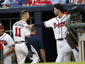 Atlanta Braves center fielder Ender Inciarte (11) holds his leg as he walks past Dansby Swanson on his way to the clubhouse after being injured in the third inning of a baseball game against the San Diego Padres, Monday, April 29, 2019, in Atlanta.