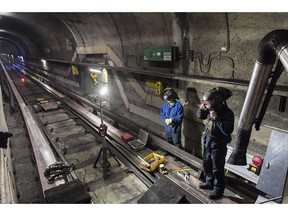 A Montreal Metro maintenance crew work on a track during the early hours of the morning in Montreal, Thursday, April 11, 2019.