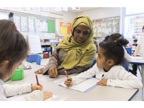 Kindergarten teacher Haniyfa Scott gives a lesson during class in Montreal, Thursday, April 4, 2019. The Quebec government's recently tabled Bill 21 bans the wearing of religious symbols for new government placed employees within schools, the courts and law enforcement.