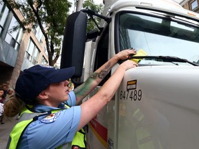 A parking enforcement officer hands out a ticket during a parking enforcement blitz in the downtown core of Toronto on Monday September 18, 2017.  A US appeals court has ruled that the practice of "tire-chalking" is unconstitutional.