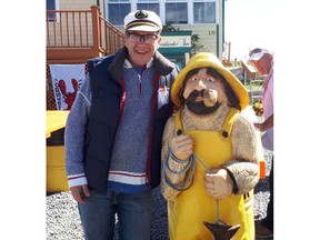 One of the most-photographed Nova Scotians is missing. Shorty, a five-foot-two wooden fisherman, was stolen from outside a tourist spot in Peggy's Cove earlier this week. Shorty and owner Peter Richardson are shown in a handout provided by Richardson. THE CANADIAN PRESS/HO-Peter Richardson MANDATORY CREDIT