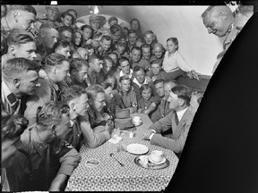 Adolph Hitler, seated at right, with group of admirers in a café. The National Archives is digitizing about 1,300 images from glass photo negatives created by Hitler's personal photographer Heinrich Hoffmann.