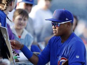 Iowa Cubs shortstop Addison Russell signs autographs before a Triple-A baseball game against the Nashville Sounds, Wednesday, April 24, 2019, in Des Moines, Iowa. Russell played in his first game of the season Wednesday for Iowa as he prepares to return to the Chicago Cubs following his domestic violence suspension.