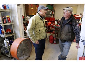 2020 Democratic presidential candidate Washington Gov. Jay Inslee talks with Ron Perry, of Hamburg, Iowa, right, while touring flood damage, Friday, April 12, 2019, in Hamburg, Iowa.