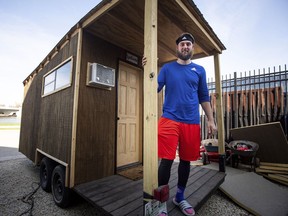 In this Monday, April 15, 2019, photo triple A Iowa Cubs pitcher Trevor Clifton poses for a photo in the tiny house he built to live in during the baseball season in Des Moines, Iowa. Trevor Clifton was 12th round draft pick by the Chicago Cubs in 2013. He made his Triple-A debut with Iowa last season after being the Cubs' top minor league pitcher in 2016.