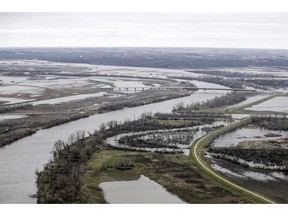 In this Friday, April 12, 2019 photo, the highway 34 bridge spans the Missouri River and it's flooded banks between La Platte, Nebraska and Glenwood, Iowa. This spring's massive flooding along the Missouri River unearthed bitter criticism of the federal agency that manages the river while devastating communities and causing more than $3 billion in damage. The flooding and the U.S. Army Corps of Engineers' actions will be the focus of a U.S. Senate hearing in western Iowa on Wednesday, April 17, 2019, and critics will demand the agency make flood control its top priority.