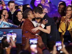Lori Lightfoot, left, kisses her spouse Amy Eshleman at her election night party Tuesday, April 2, 2019, in Chicago. Lori Lightfoot elected Chicago mayor, making her the first African-American woman to lead the city.