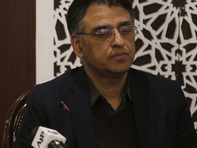 FILE - In this Tuesday, Feb. 26, 2019 file photo, Pakistan's Finance Minister Asad Umar attend a meeting in Islamabad, Pakistan. Pakistan's finance minister says he will step down amid a wave of criticism over the government's handling of a financial crisis that has sent prices soaring. Umar tweeted Thursday, April 18, 2019 that Prime Minister Imran Khan offered him the energy portfolio in the Cabinet but he refused. He defended Khan's leadership, calling him the "best hope" for Pakistan.