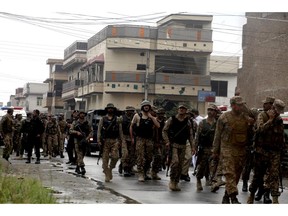 Pakistan army soldiers leave after the crackdown operation against terrorists in Peshawar, Pakistan, Tuesday, April 16, 2019. Pakistani authorities say a raid by security forces on a militant hideout in the northwestern city of Peshawar triggered a 15-hour shootout in which a police officer and many suspected militants were killed.