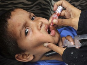 A health worker gives a polio vaccination to a child in Lahore, Pakistan, Monday, April 22, 2019. A Pakistani health official says the country has kicked off a nationwide polio vaccination campaign for the year in efforts to eradicate the crippling disease by the end of 2019. Pakistan reported only eight new polio cases in 2018.