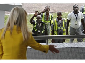 U.S. White House senior adviser Ivanka Trump, left, waves back at airport workers as one blows a kiss and others wave as she arrives at the airport in Abidjan, Ivory Coast, Tuesday April 16, 2019, after flying in from Ethiopia. Trump is visiting Ivory Coast to promote a White House global economic program for women, after a previous stop in Ethiopia.