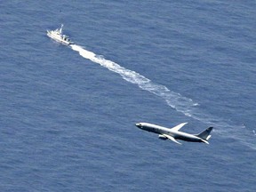 A Japan Coast Guard vessel and U.S. military plane search for a Japanese fighter jet, in the waters off Aomori, northern Japan, Wednesday, April 10, 2019.