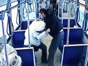 A screen shot from an  Edmonton Transit System video that was played for the jury at the second-degree murder trial of Jeremy Newborn, 32, and showed the accused repeatedly punching victim John Hollar, 29, as shocked passengers watch and move away.