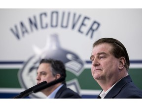 Vancouver Canucks general manager Jim Benning, right, and head coach Travis Green pause for a moment during a news conference at Rogers Arena in Vancouver on Monday, April 8, 2019. The Canucks finished their season this past weekend failing to make the 2019 playoffs.