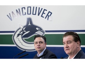 Vancouver Canucks general manager Jim Benning, right, and head coach Travis Green pause for a moment during a news conference at Rogers Arena in Vancouver on Monday, April 8, 2019. The Canucks finished their season this past weekend failing to make the 2019 playoffs.