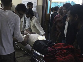 An Injured of rain storm from Bara district is being brought to a government hospital, in Birgunj, 136 kilometers (85 miles) from Kathmandu, Nepal, March 31, 2019. Officials say many people were killed and hundreds were injured by a rainstorm that swept southern Nepal on Sunday.