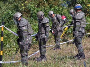 In this Oct. 2, 2018, file photo, South Korean army soldiers search for landmines inside the Demilitarized Zone (DMZ) that separates the two Koreas in Cheorwon, South Korea. South Korea's military on Monday, April 1, 2019, is separately searching for Korean War remains at the heavily armed inter-Korean border after North Korea ignored its calls to carry out a previously planned joint search.