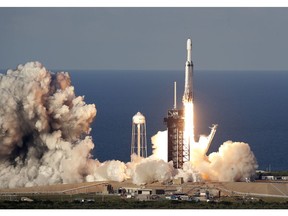 A SpaceX Falcon Heavy rocket carrying a communication satellite lifts off from pad 39A at the Kennedy Space Center in Cape Canaveral, Fla., Thursday, April 11, 2019.