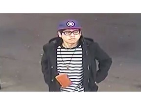 This May 25, 2018 image from surveillance video released by the New South Wales Police Force shows Wachira "Mario" Phetmang, 33, entering a service station in South Hurstville, a suburb of Sydney. Authorities have identified an American suspect in the killing of Phetmang, a Thai national whose battered body was found bound, gagged and wrapped in plastic on the side of a road in a high-profile case in Australia, according to a federal search warrant obtained Tuesday, April 9. 2019. (New South Wales Police via AP)
