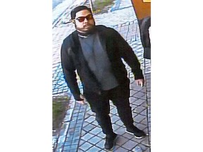 This Feb. 22, 2019 image from surveillance video at the North Korean Embassy to Spain in Madrid, contained in Department of Justice documents presented by federal prosecutors, shows U.S. Marine veteran Christopher Ahn as he prepares to enter the embassy. Ahn, suspected of involvement in a mysterious dissident group's February raid on North Korea's embassy, has been denied bond by a federal judge and must stay in custody. Ahn appeared in a Los Angeles courtroom on Tuesday, April 23. The charges against Ahn haven't been made public. (U.S. Department of Justice via AP)
