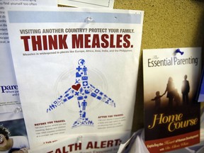 FILE - In this Feb. 6, 2015, file photo, a flyer educating parents about measles is displayed on a bulletin board at a pediatrics clinic in Greenbrae, Calif. State health officials say the number of measles cases is up in California in 2019 and much of the increase is linked to overseas travel. Dr. Karen Smith, director of the California Department of Public Health, says the state recorded 38 measles cases as of Thursday, April 25, 2019, versus 11 around the same time last year. She says the state typically sees fewer than two dozen cases a year.