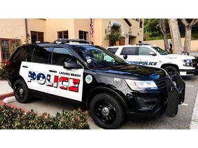 This undated photo provided by the Laguna Beach Police Department shows their newly decorated Police SUV patrol vehicles in Laguna Beach, Calif. An American flag graphic on the side of freshly painted police cars is dividing a small coastal city in Southern California. Some people in Laguna Beach feel the flag design is too aggressive while others are astonished that anyone would object to the American flag, The Los Angeles Times reported Saturday, April 13, 2019. (Laguna Beach Police Department via AP)