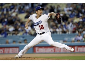 Los Angeles Dodgers starting pitcher Kenta Maeda throws to a Cincinnati Reds batter during the first inning of a baseball game Tuesday, April 16, 2019, in Los Angeles.