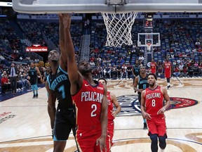 New Orleans Pelicans guard Ian Clark (2) drives to the basket in front of Charlotte Hornets forward Marvin Williams (2) in the first half of an NBA basketball game in New Orleans, Wednesday, April 3, 2019.